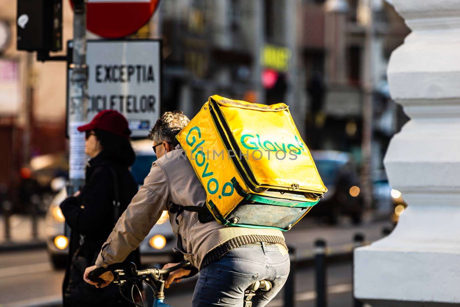 A Glovo food delivery courier on a bike. Restaurants are closed  by vladispas