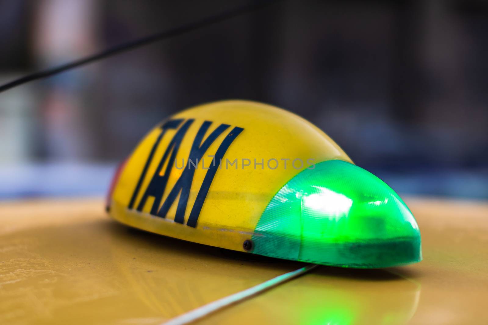 Detail of taxi sign on yellow taxi car in Bucharest, Romania by vladispas