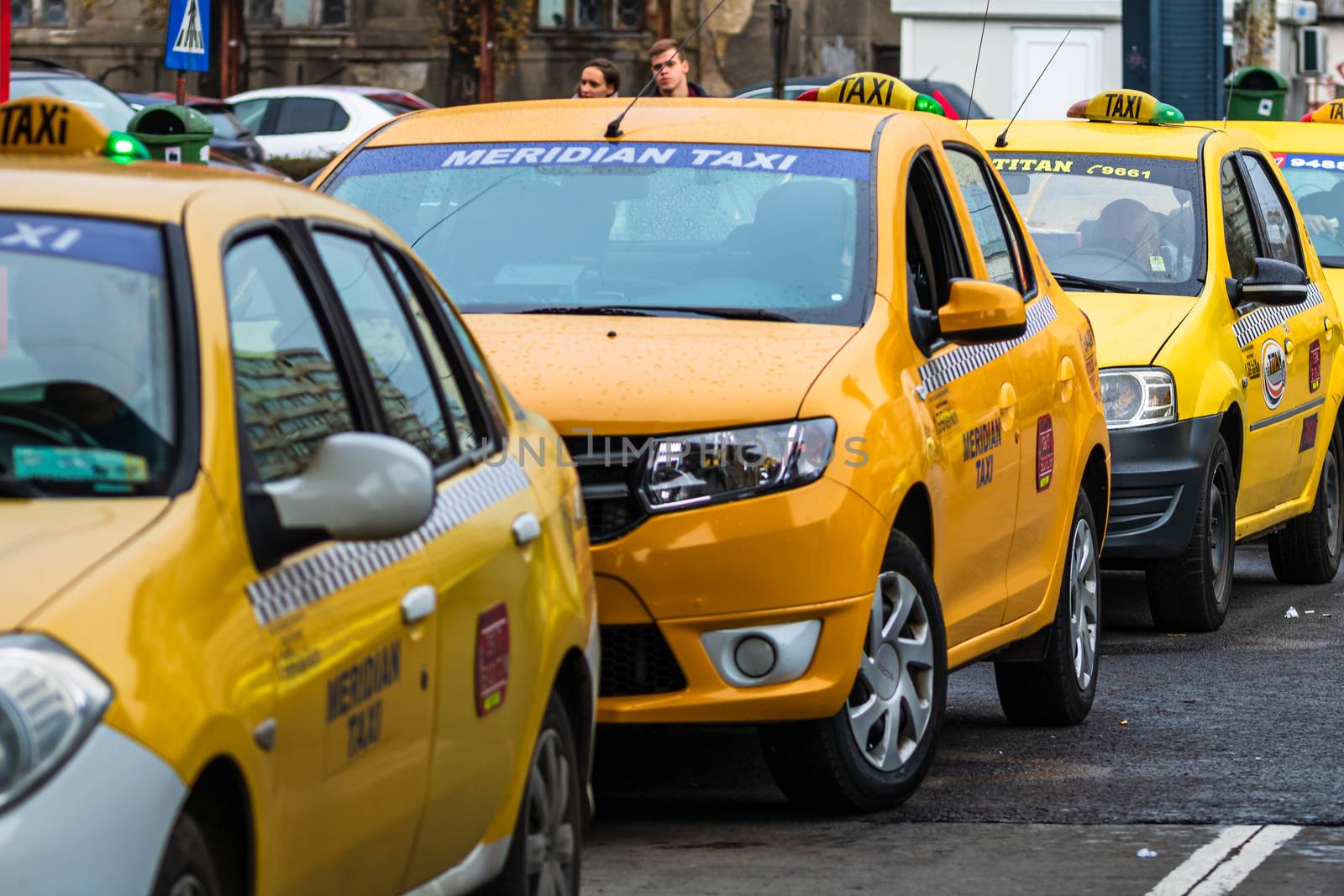 Car in traffic, modern city taxi service. Taxi cars parked at the taxi station in the capital city of Bucharest, Romania, 2020