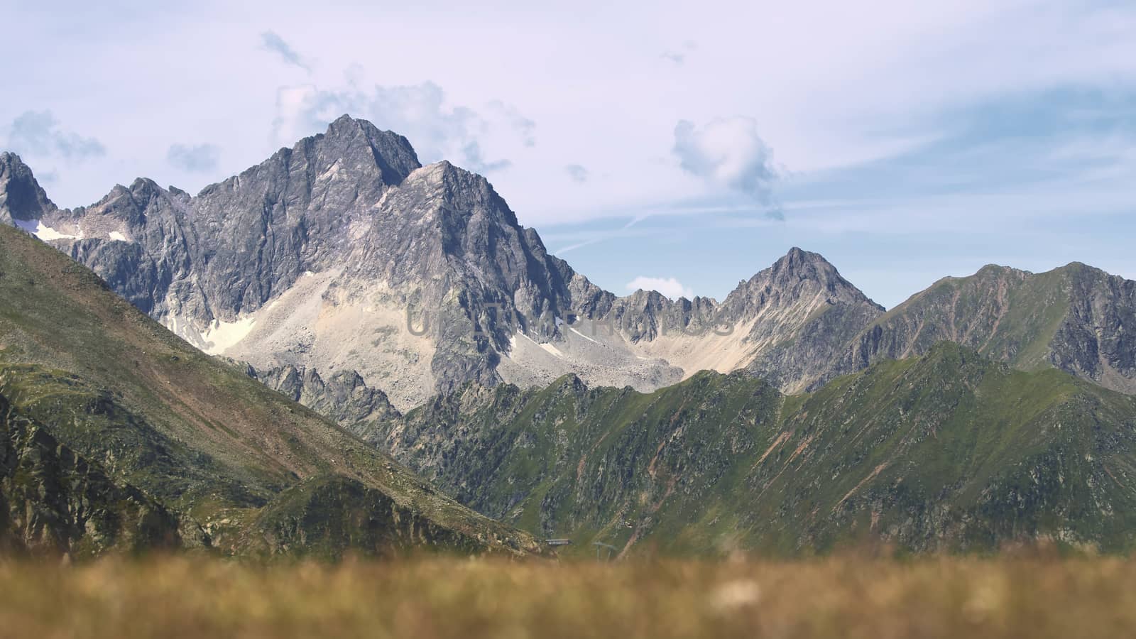 The high mountains of the Austrian Alps in Kuhtai during summer season. The sunshine illuminates the beautiful landscape.