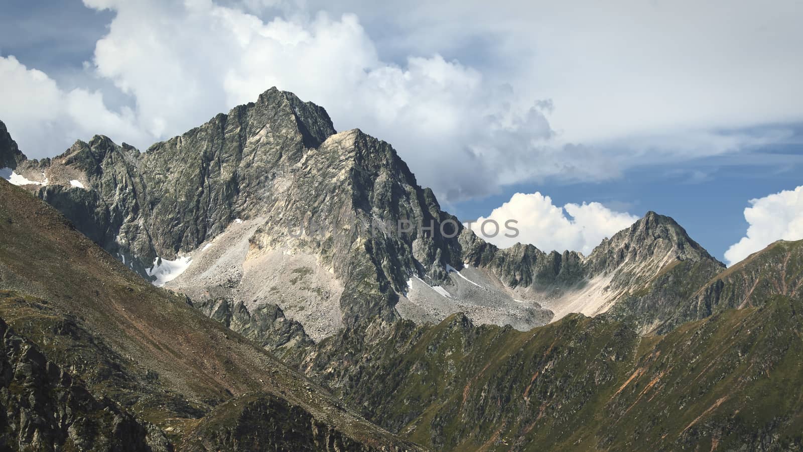 The high mountains of the Austrian Alps in Kuhtai during summer season. The sunshine illuminates the beautiful landscape.