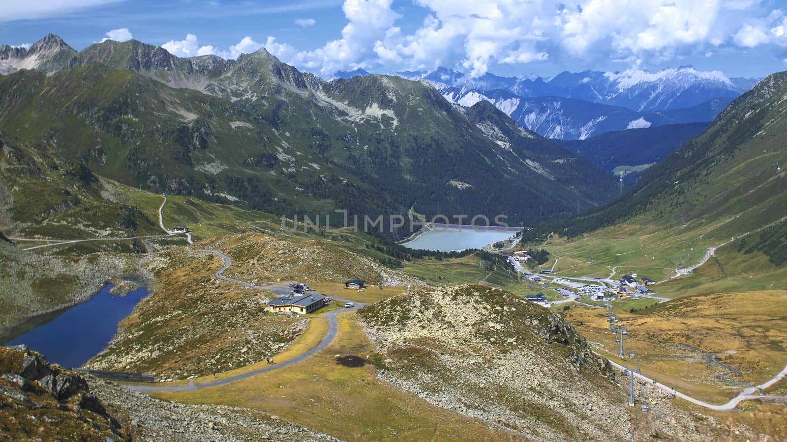 The high mountains of the Austrian Alps in Kuhtai during summer season. The sunshine illuminates the beautiful landscape.