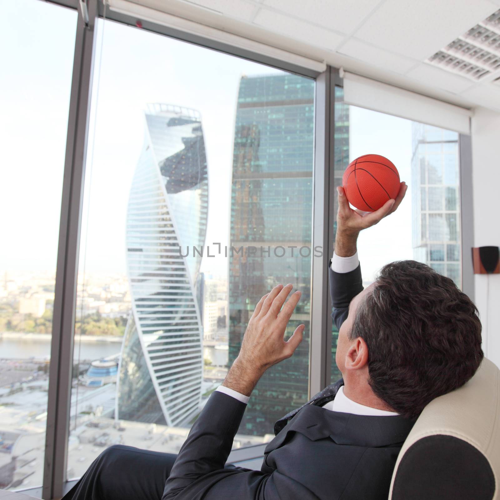 Businessman with basketball by ALotOfPeople