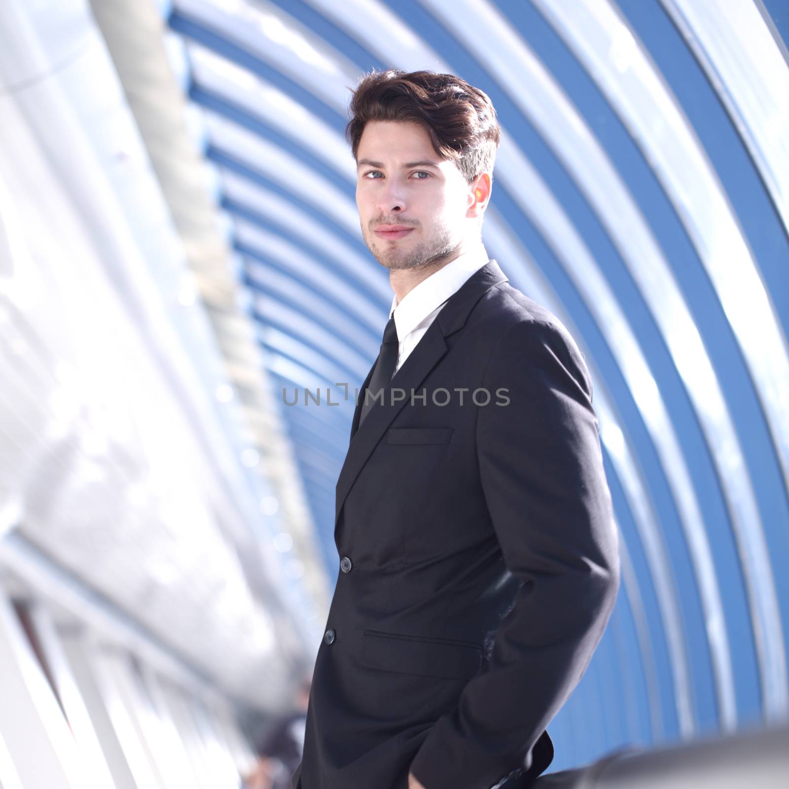 Young Businessman standing in corridor of modern office building