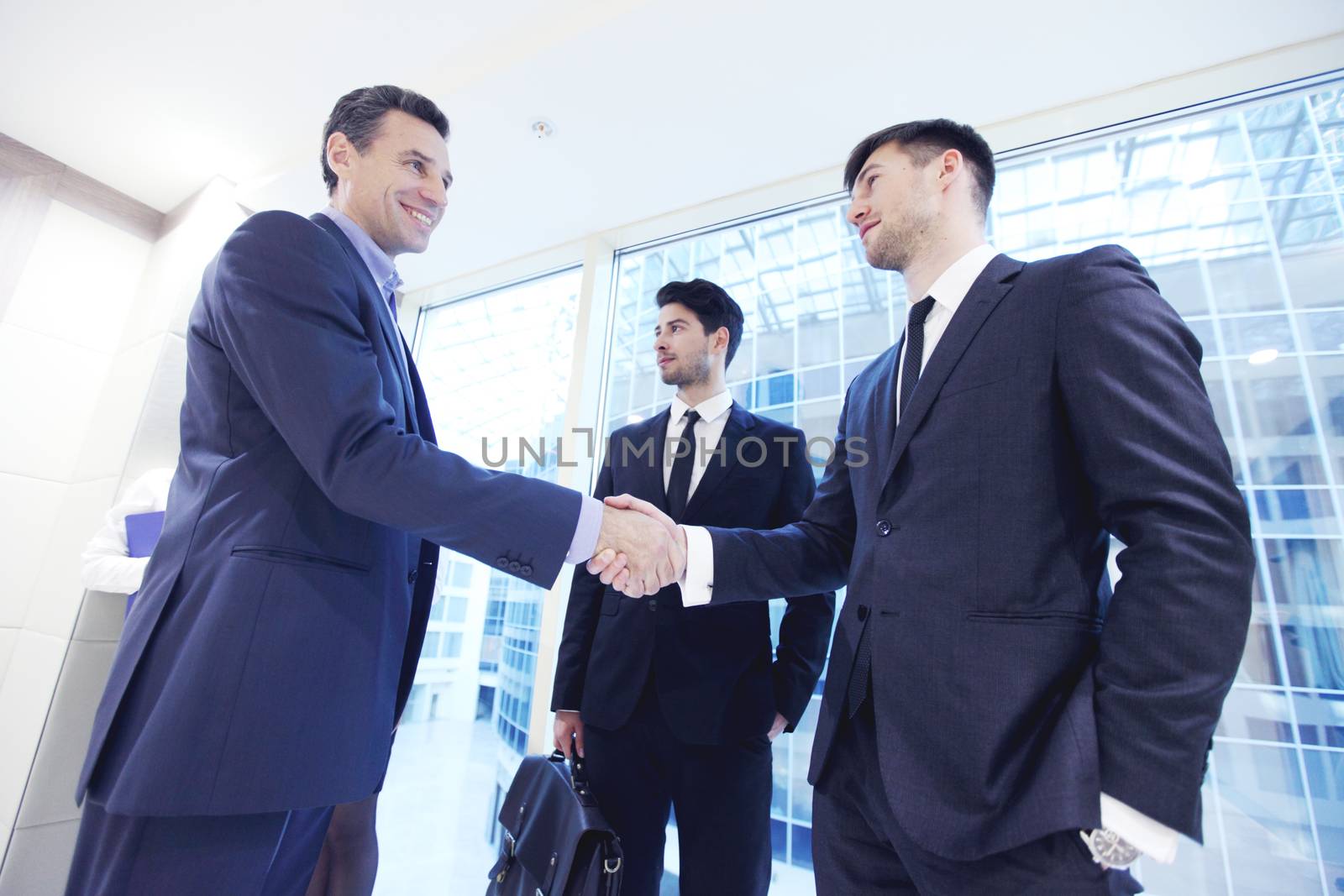 Business people shaking hands, finishing up a meeting in office
