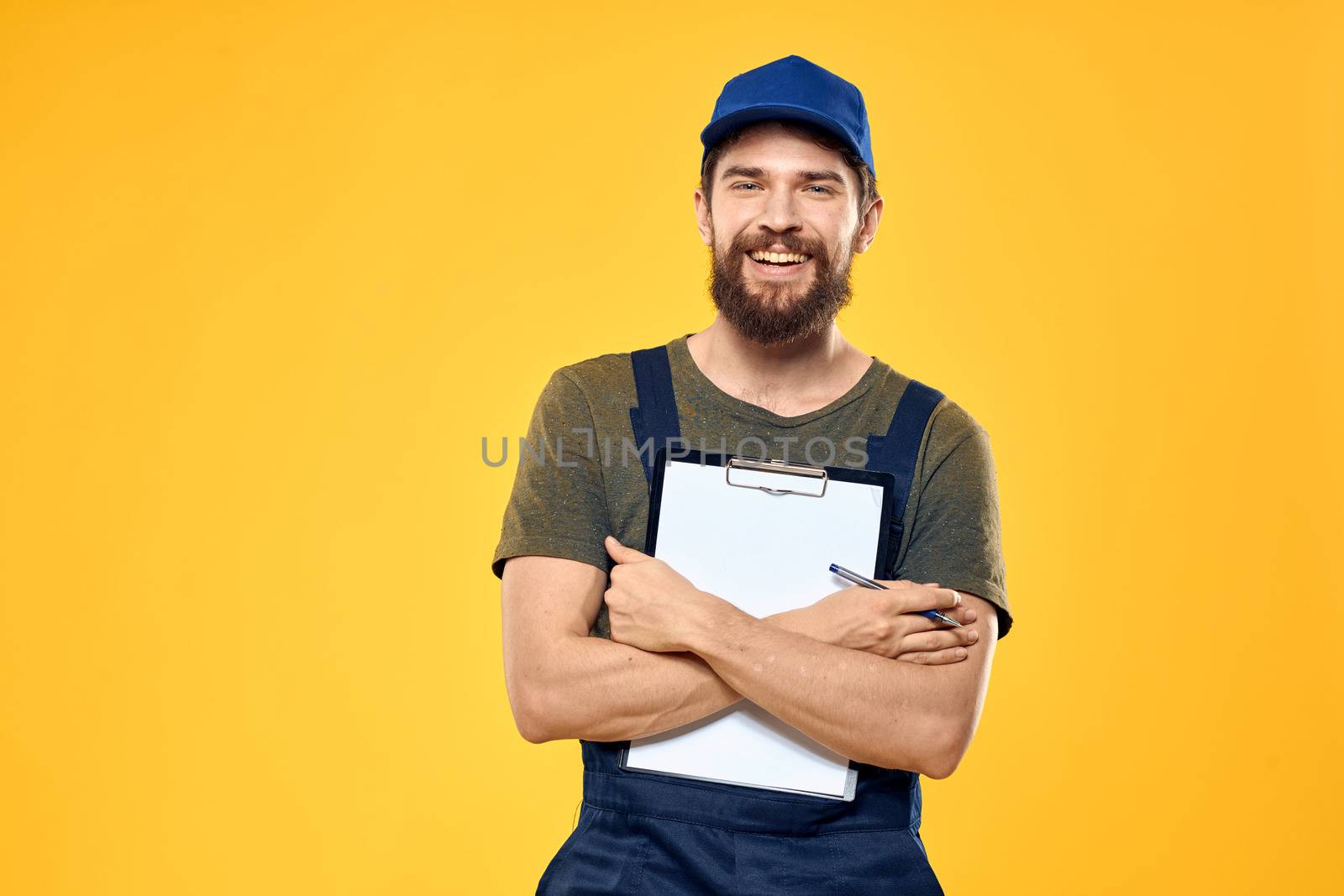 Man in working form documents transportation delivery service yellow background. High quality photo