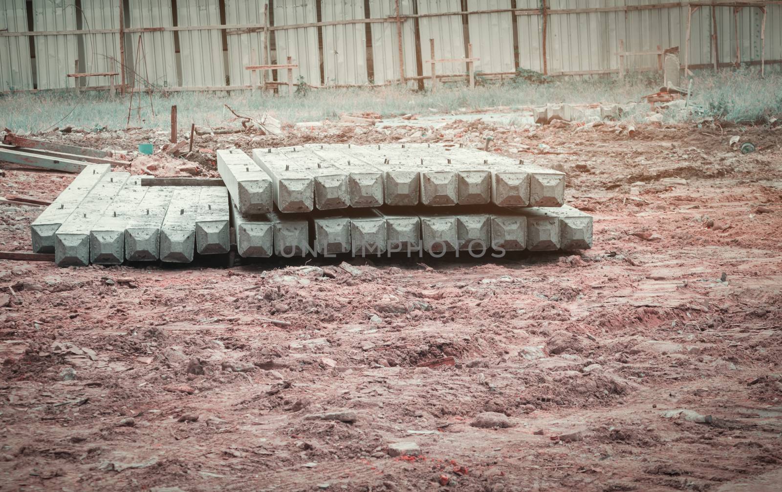 pile concrete pillars on ground in construction site by pramot