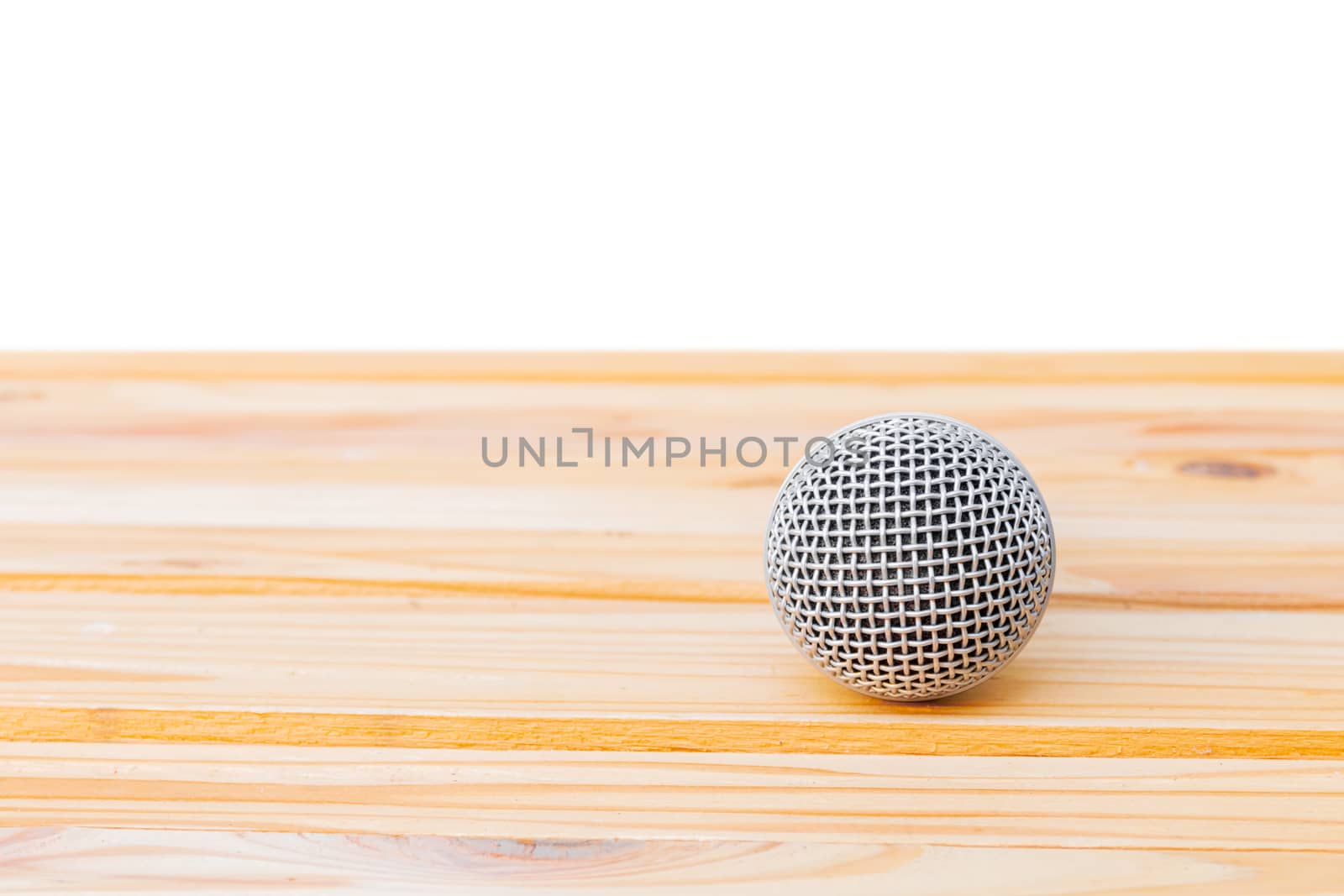 microphone dynamic on wooden table yellow with white background by pramot