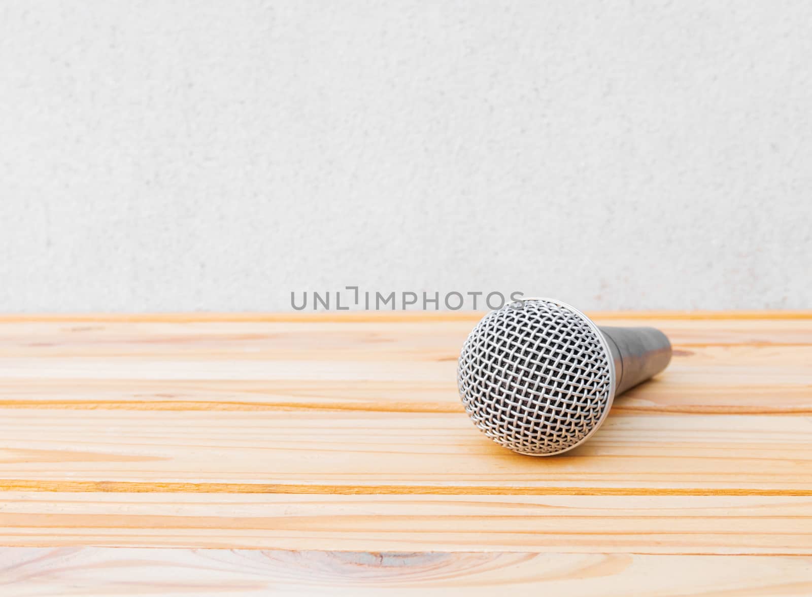 microphone dynamic on wooden table yellow with white background by pramot