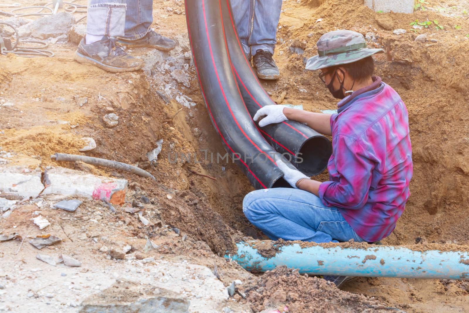 repair water pipes black and worker On the ground by pramot
