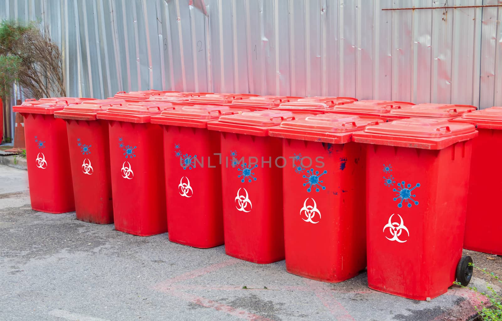 red bins group with symbol infectious in the outdoors keep clean from germs virus. concept prevent garbage infection coronavirus (covid-19)