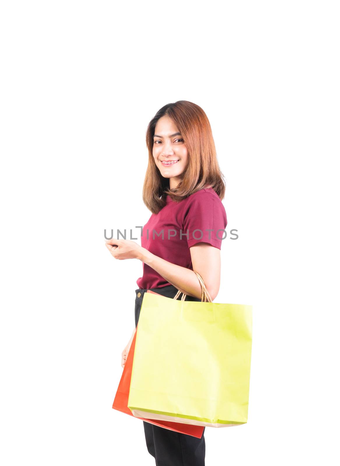 young woman pretty smiling holding paper bags green and orange by pramot