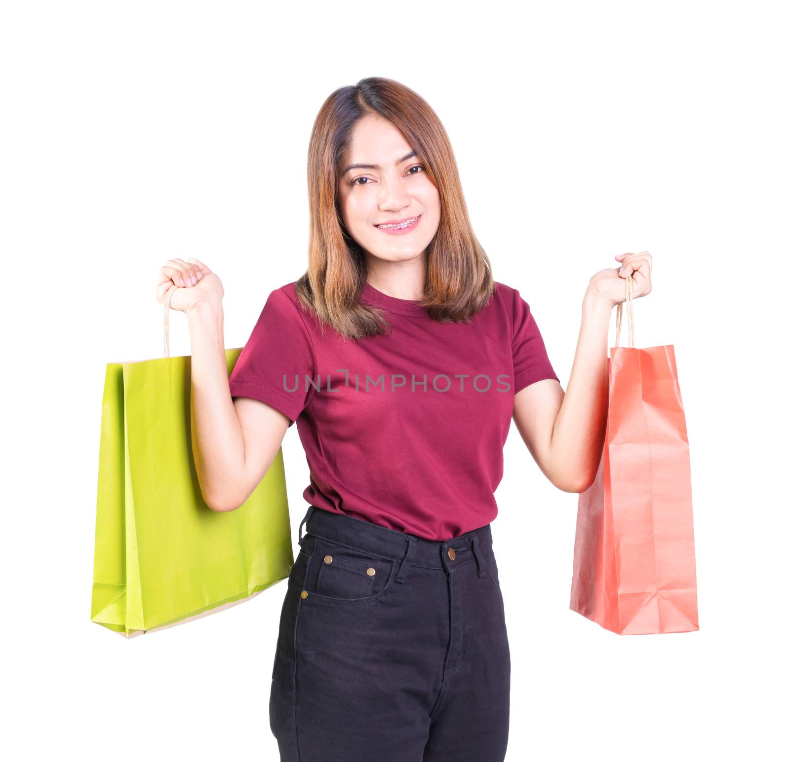 young woman pretty smiling holding paper bags green and orange by pramot