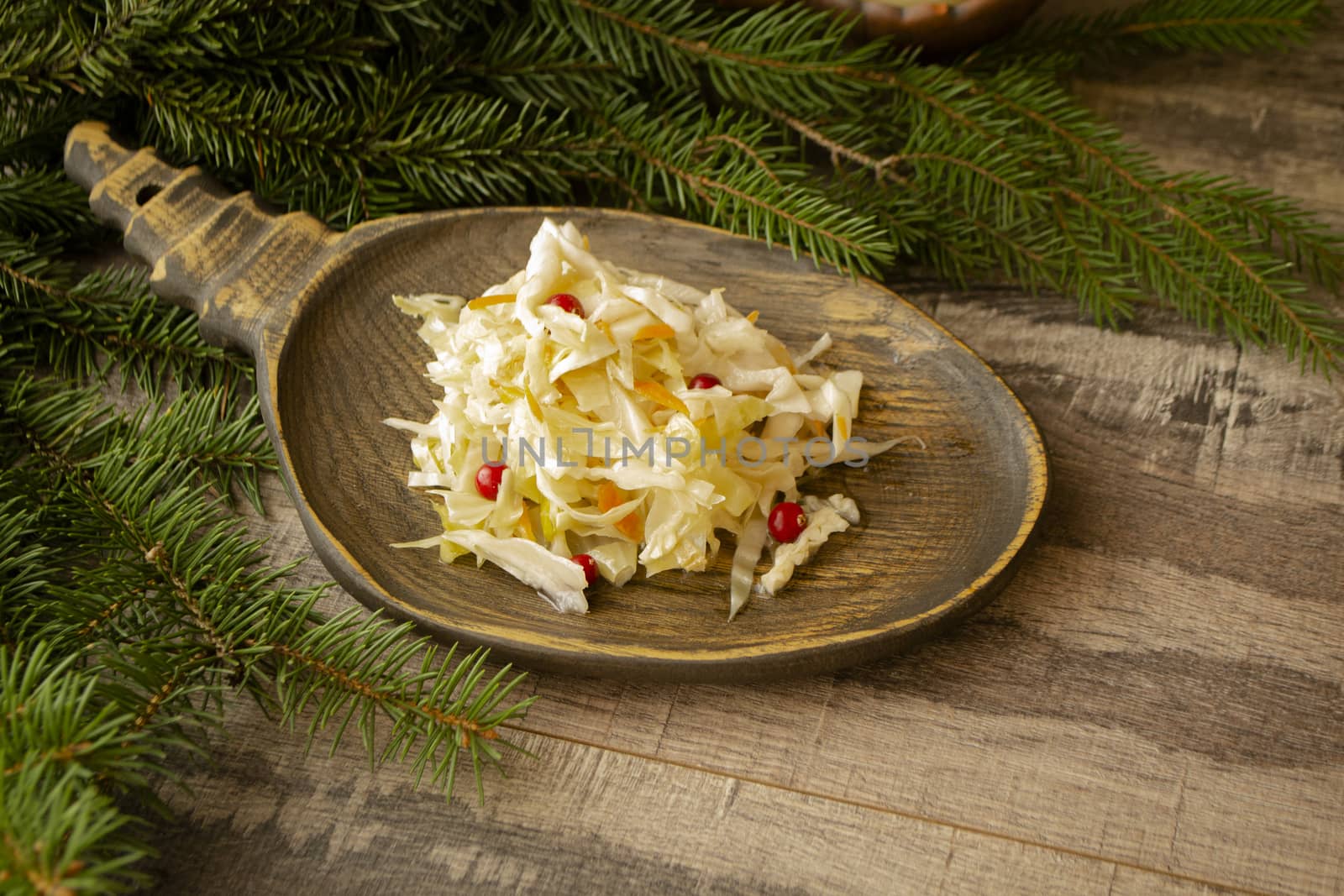 pickled cabbage and carrots on wooden rustic plate