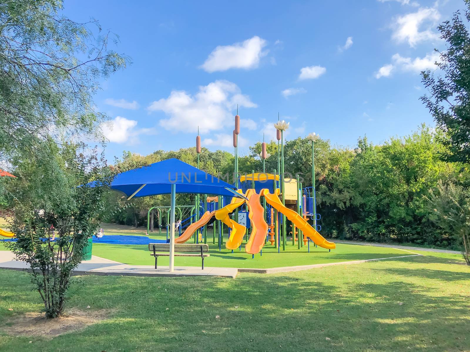 Residential area playground with sun shade sails and artificial grass in Flower Mound, Texas, USA by trongnguyen