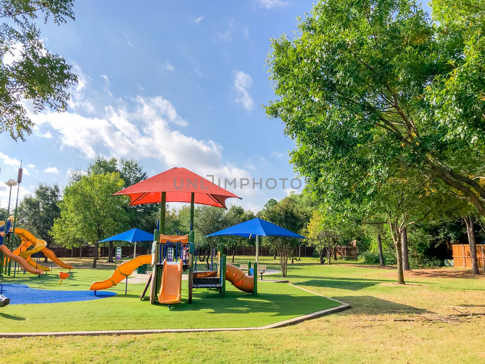 Residential area playground with sun shade sails and artificial grass in Flower Mound, Texas, USA by trongnguyen