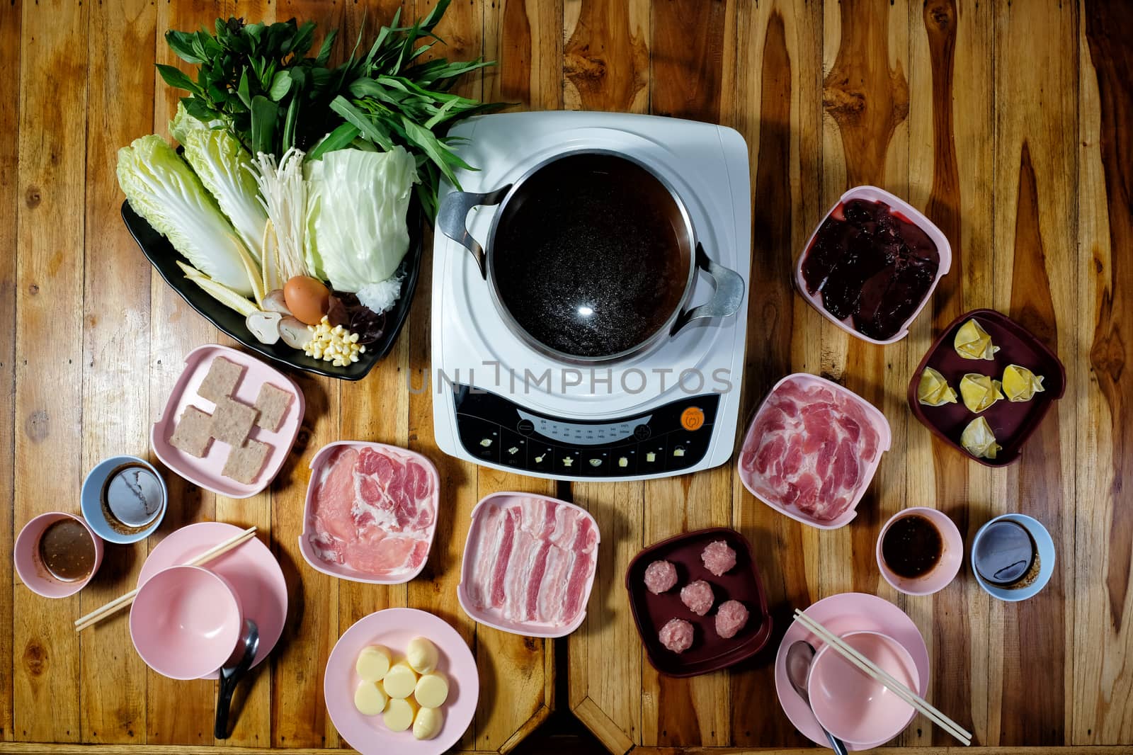 Thai style hot pot with delicious food ingredient on wood background