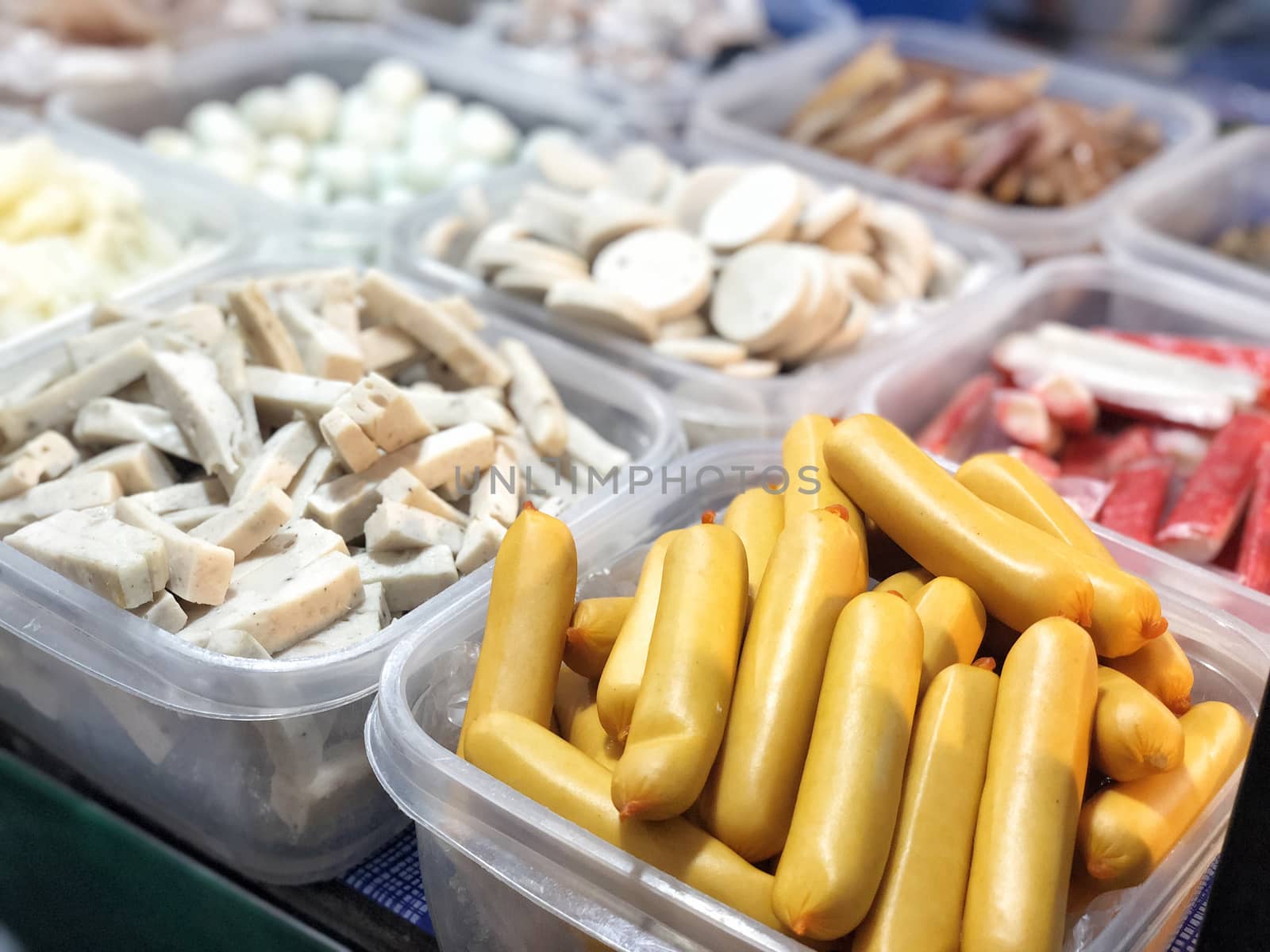 Ingredient for spicy salad: Vietnamese pork sausage, dory fish fillet, calamari, and meatballs in plastic food boxes