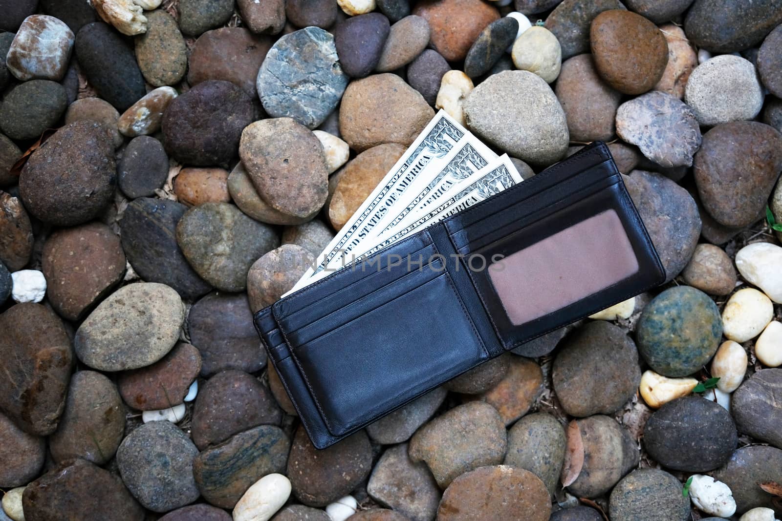 A man lost wallet on the ground by Surasak