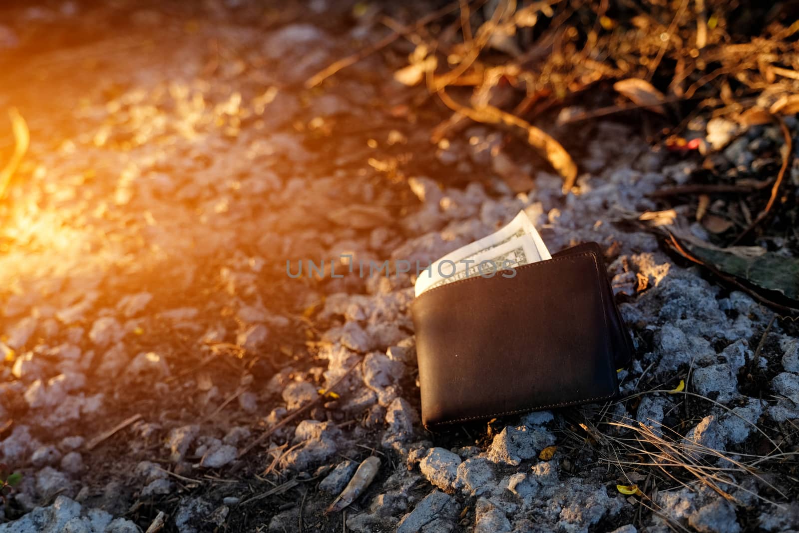 A man lost wallet on the ground by Surasak