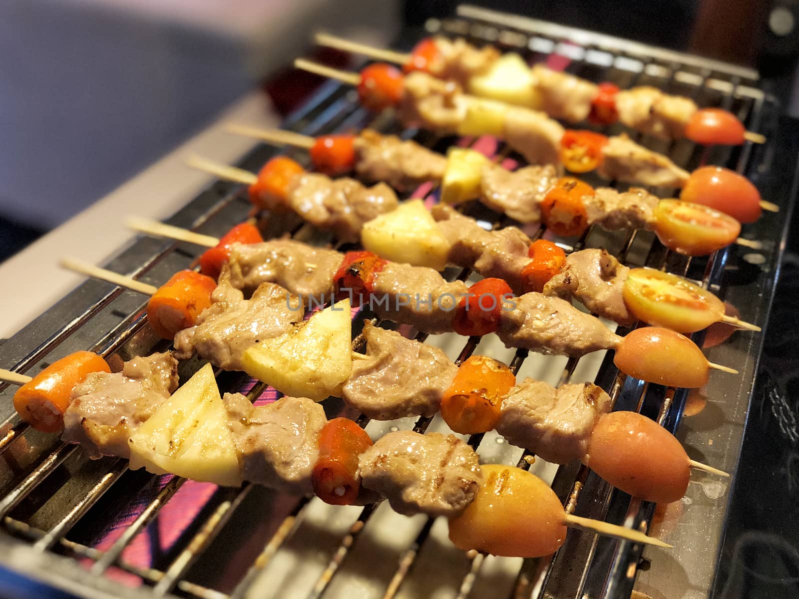Chicken and pork and various vegetables on barbecue grill cooked by Surasak