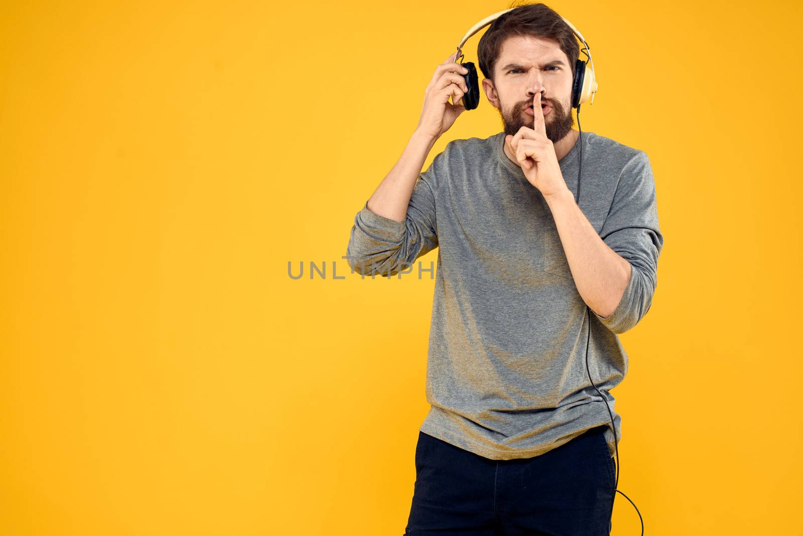Man with headphones music lifestyle lifestyle technology yellow background by SHOTPRIME