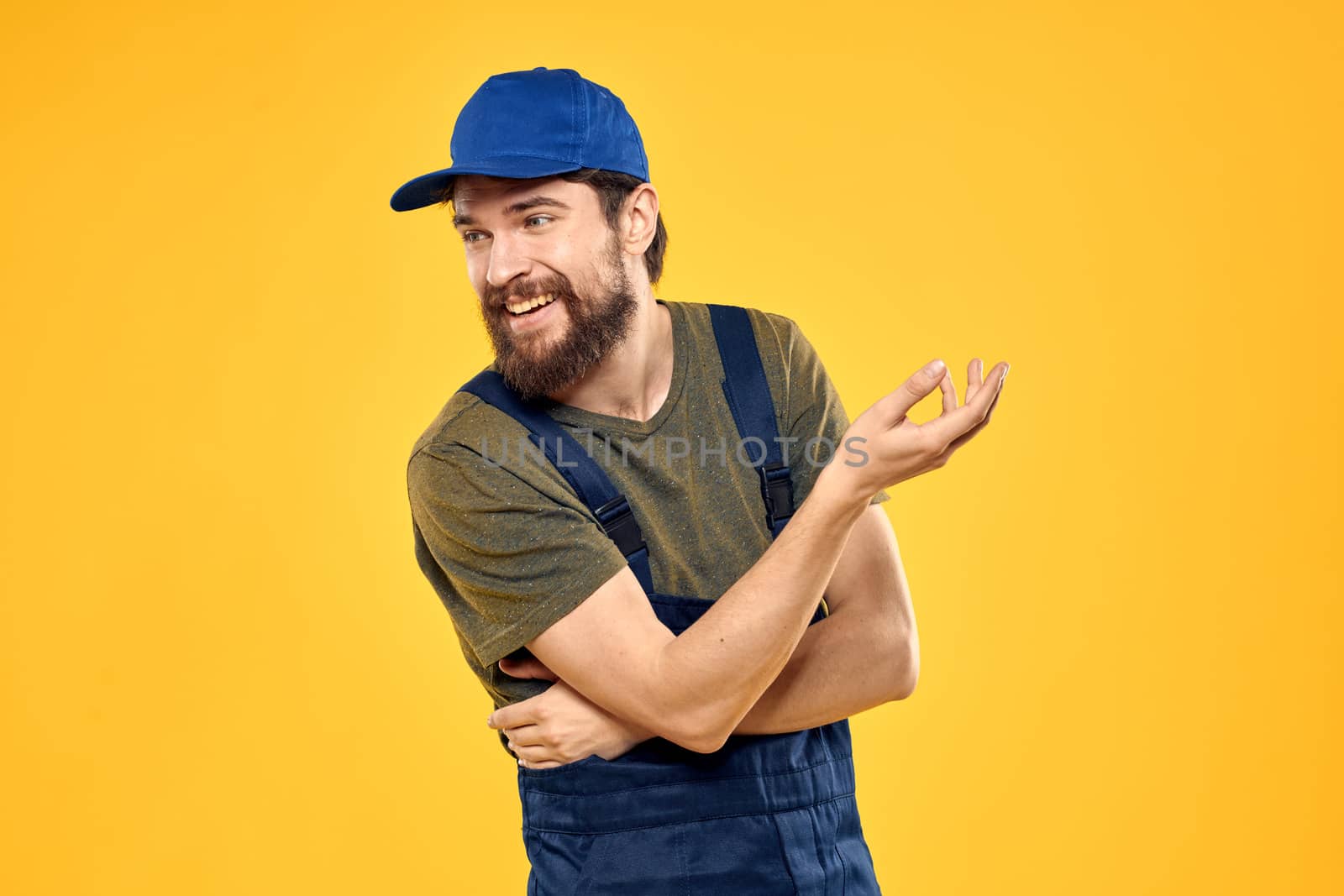 man in work uniform rendering service forklift work lifestyle yellow background. High quality photo