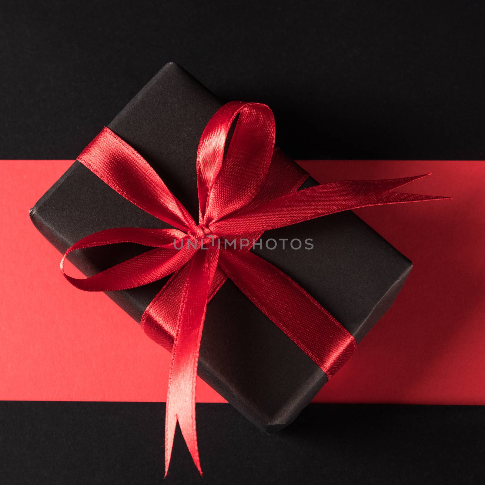 Gift box wrapped black paper and black bow ribbon present by Sorapop