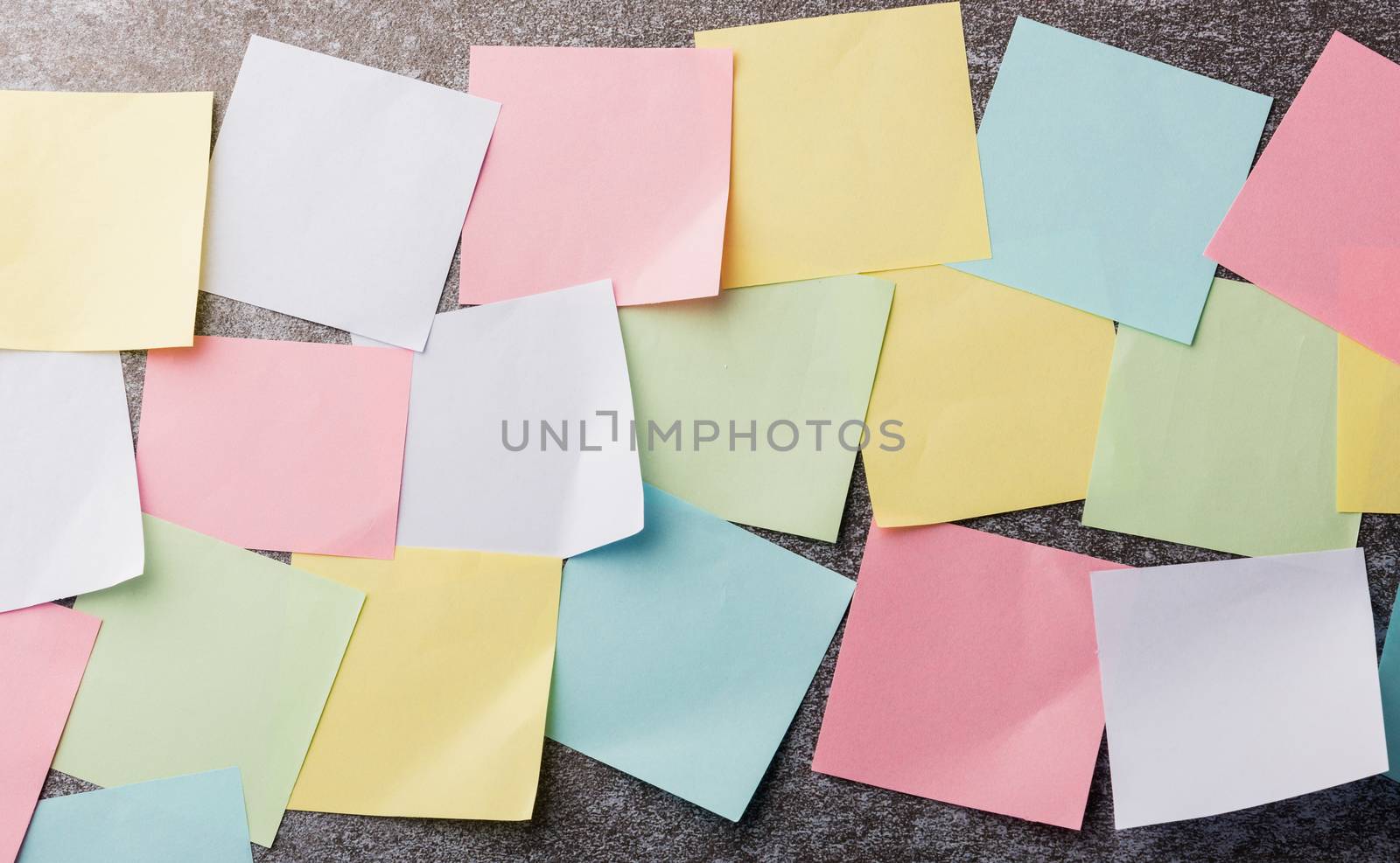 Many blank multicolored paper stick note list on concrete wall background, Business reminder memory post-it notes work today concept