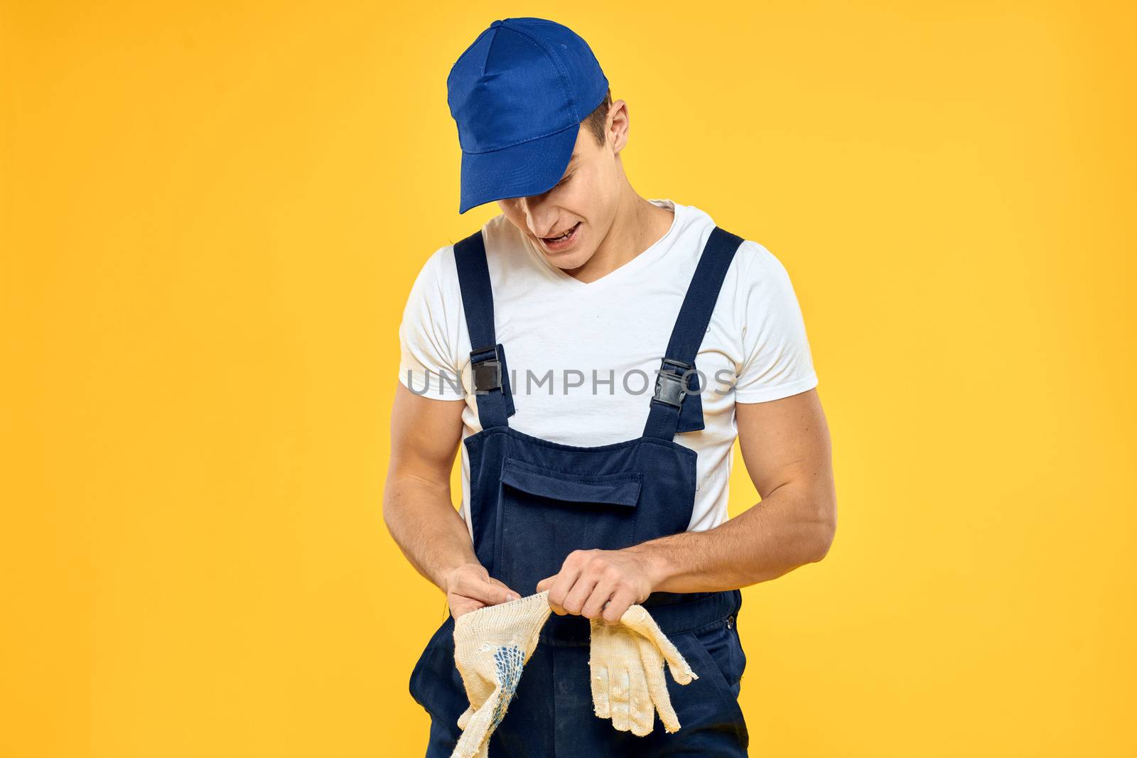 Man in working uniform documents rendering of services delivery service yellow background by SHOTPRIME
