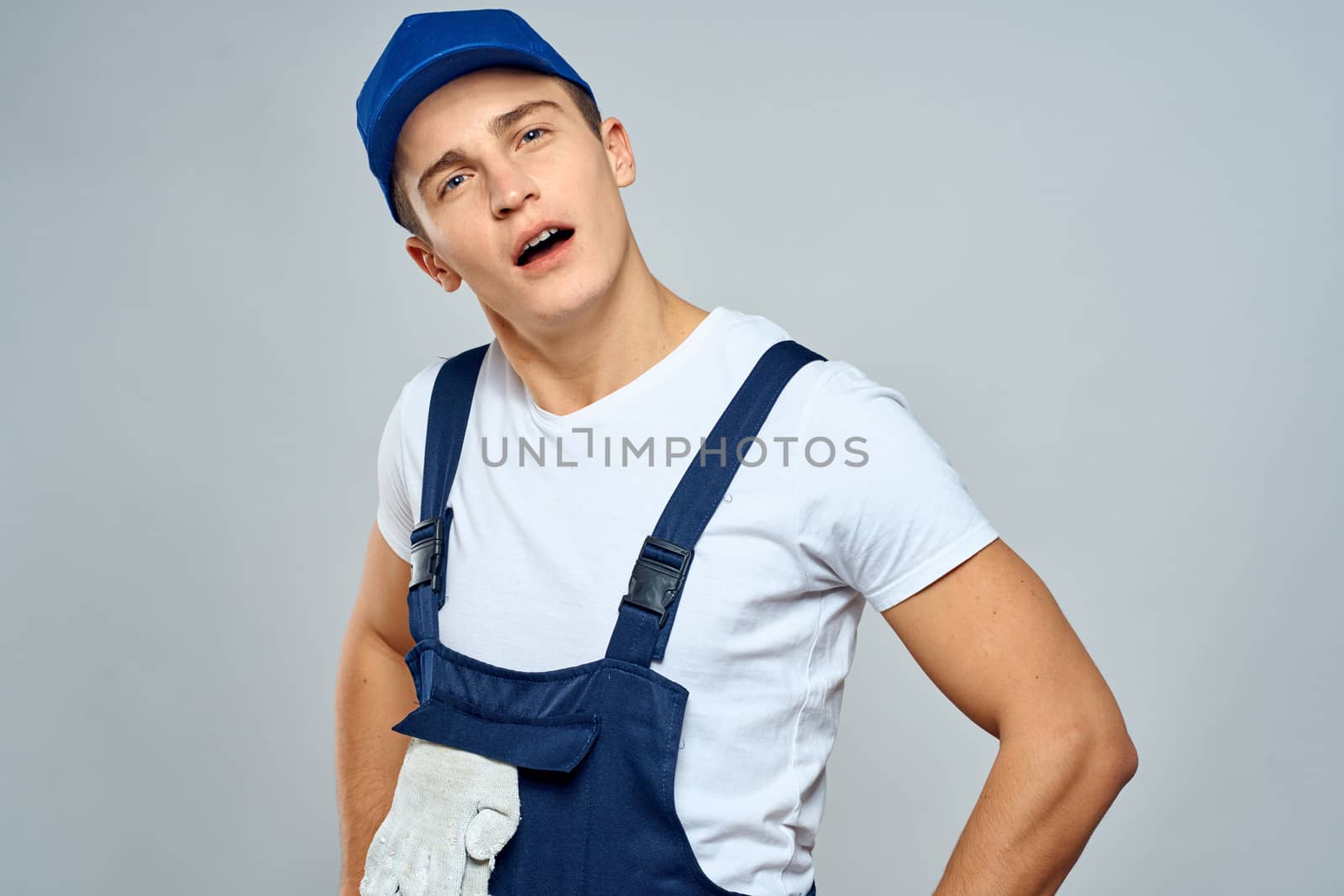 working man in uniform service lifestyle delivery service light background by SHOTPRIME