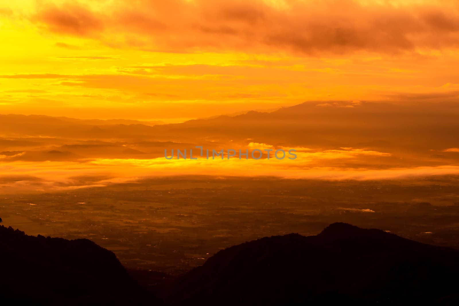 Beautiful landscape at sunset sky with clouds on peak of mountai by TEERASAK