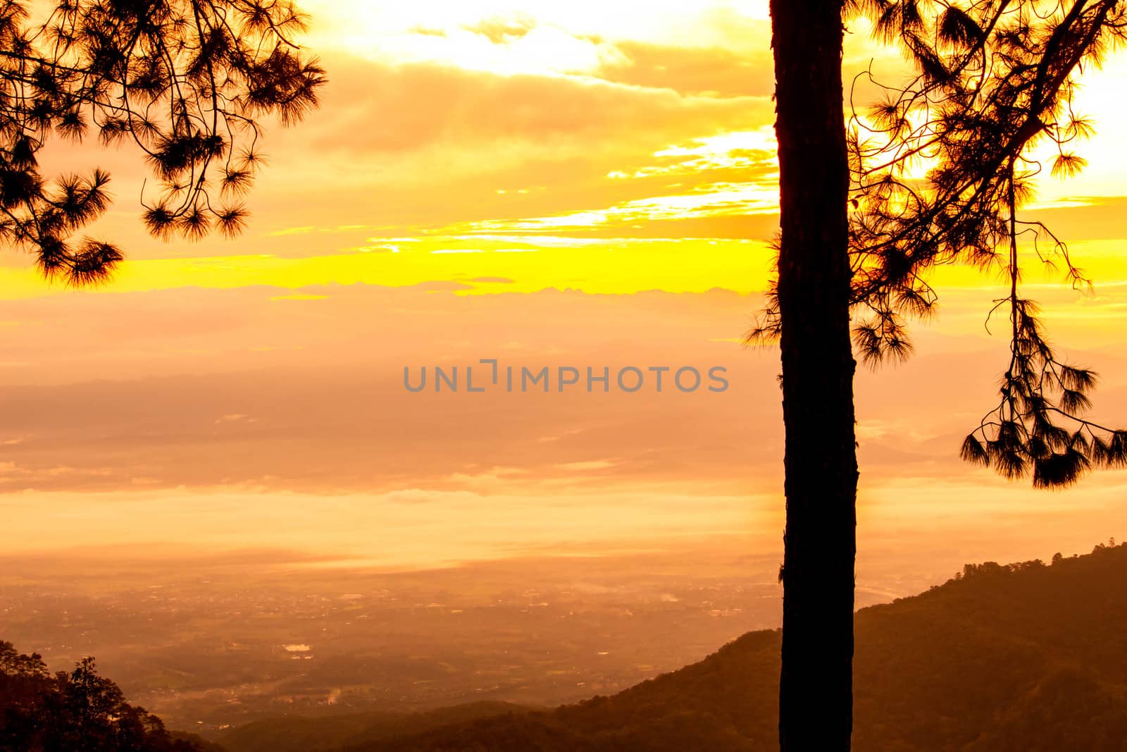 Beautiful landscape at sunset sky with clouds on peak of mountains.