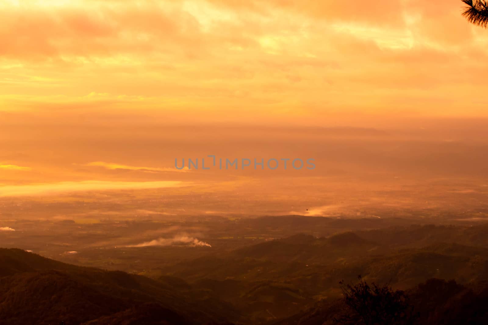 Beautiful landscape at sunset sky with clouds on peak of mountains.