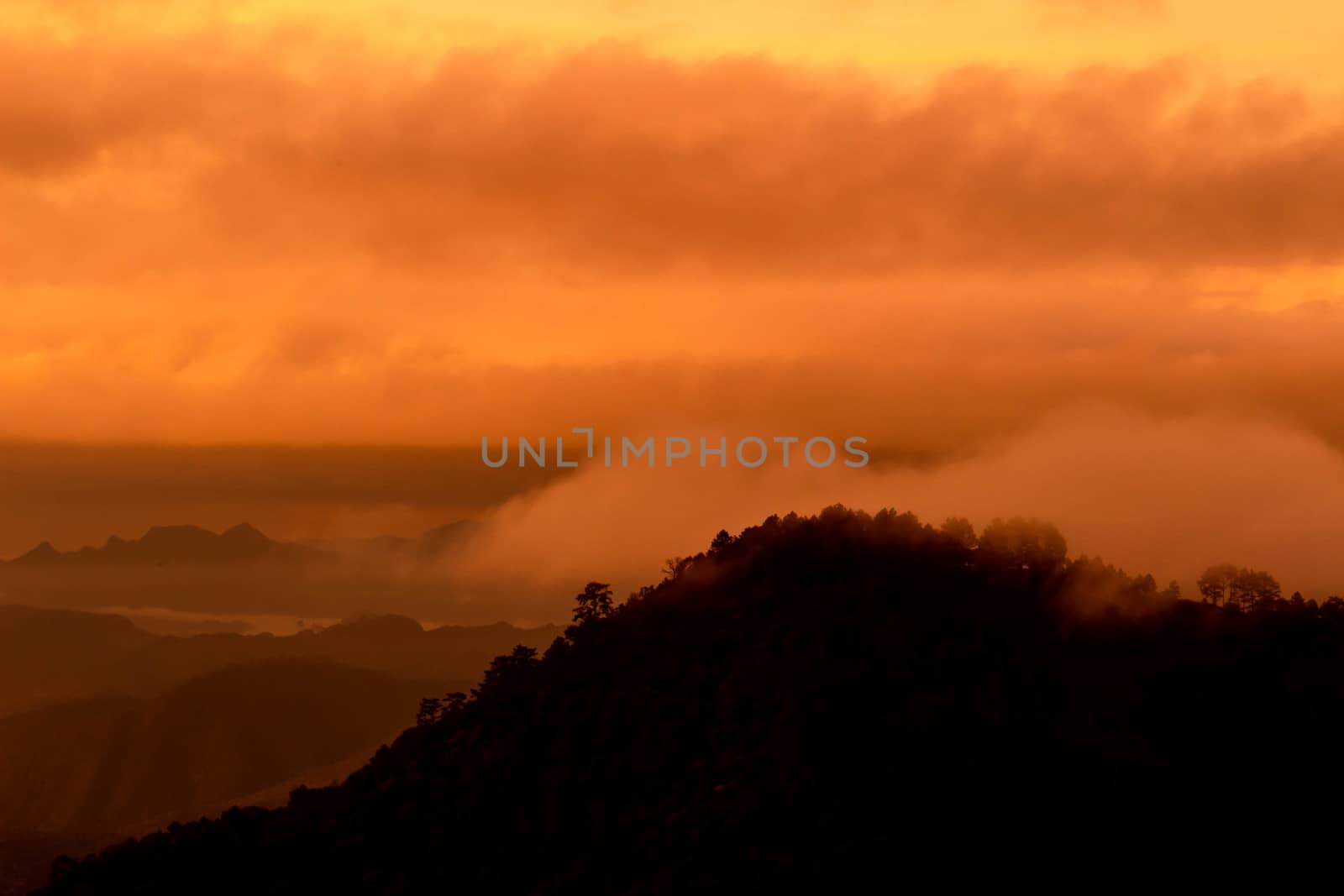 Beautiful landscape at sunset sky with clouds on peak of mountai by TEERASAK