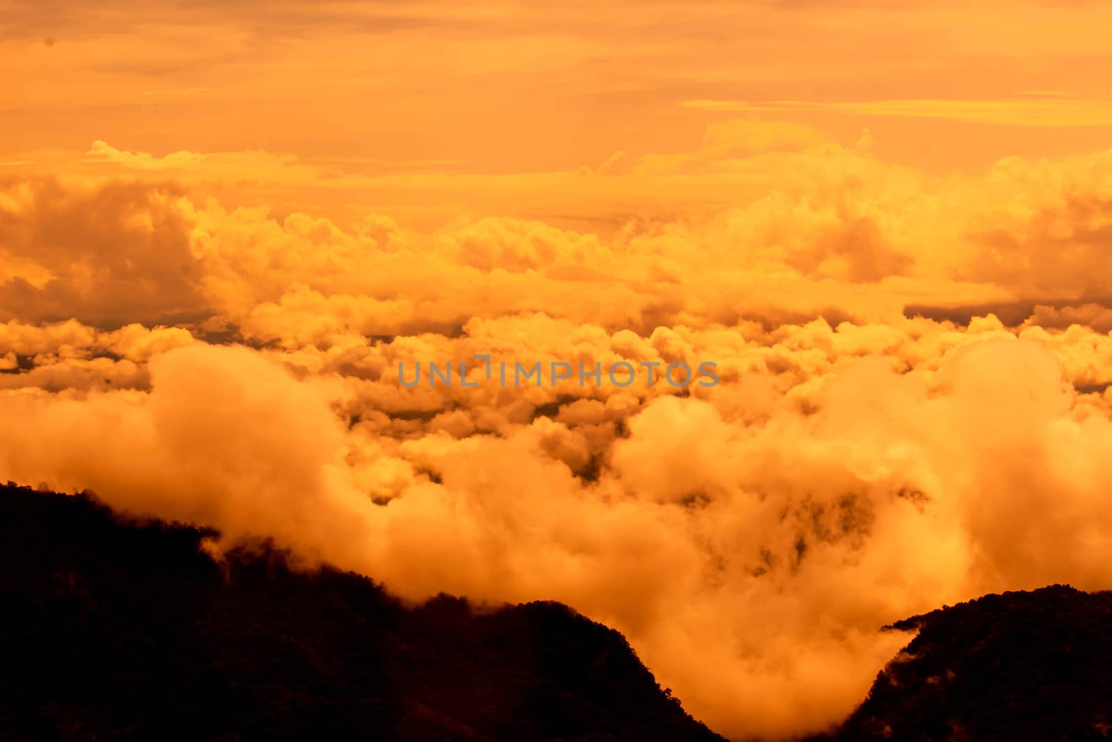 Beautiful landscape at sunset sky with clouds on peak of mountai by TEERASAK