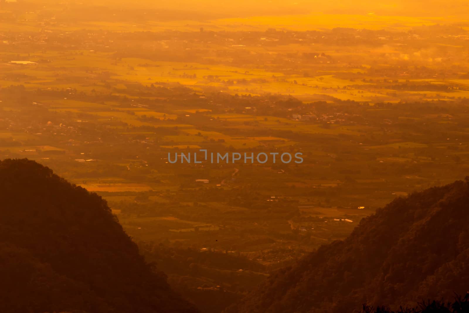 Beautiful landscape at sunset sky with clouds on peak of mountains.