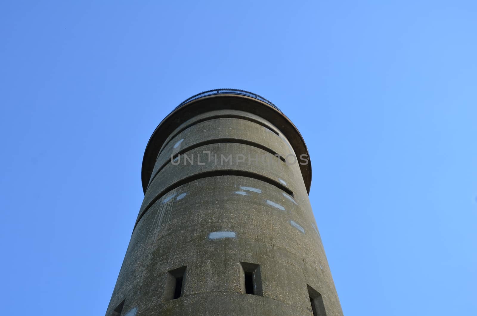 tall cement tower structure or building with blue sky