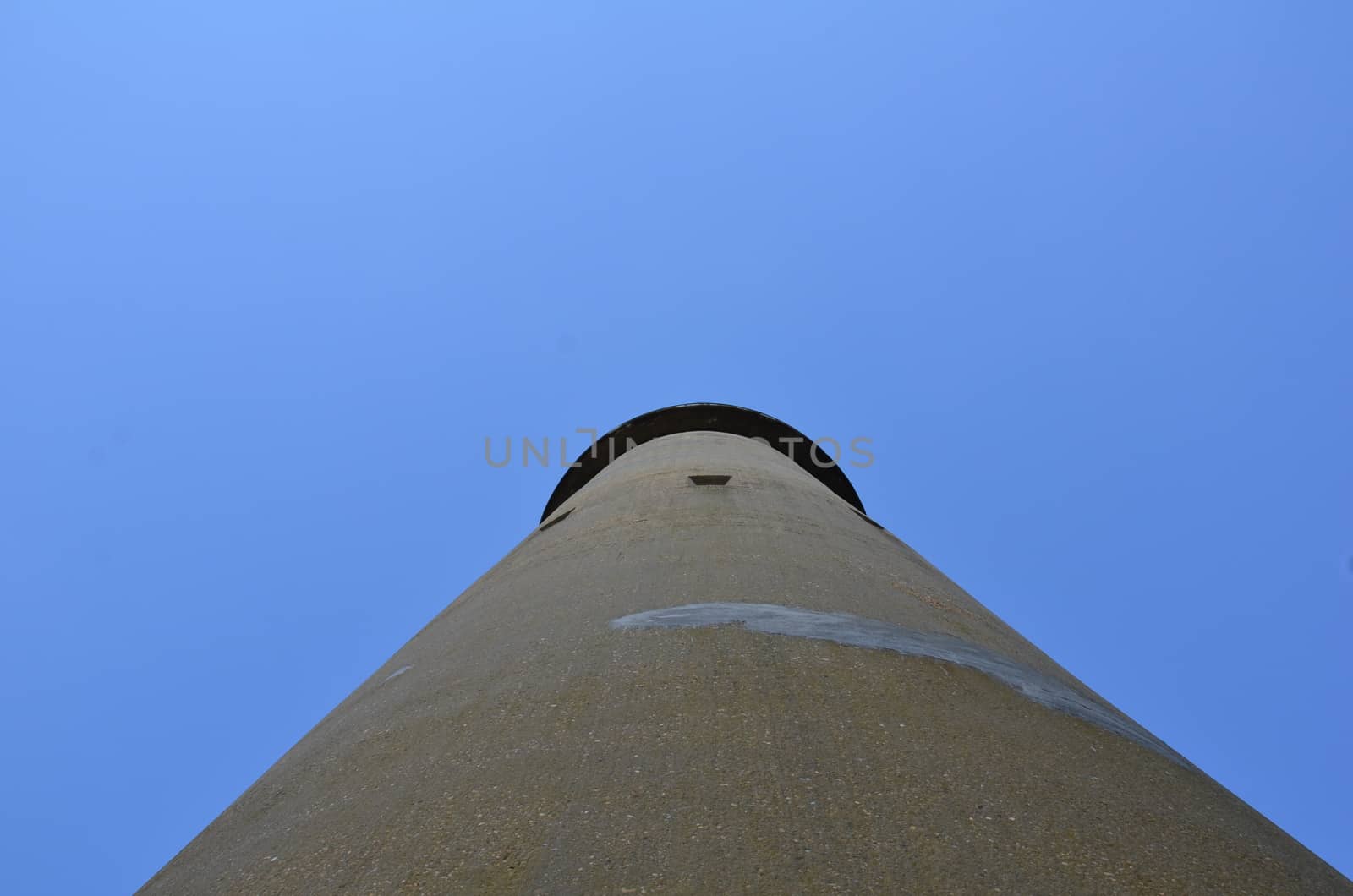 tall cement tower structure with blue sky by stockphotofan1