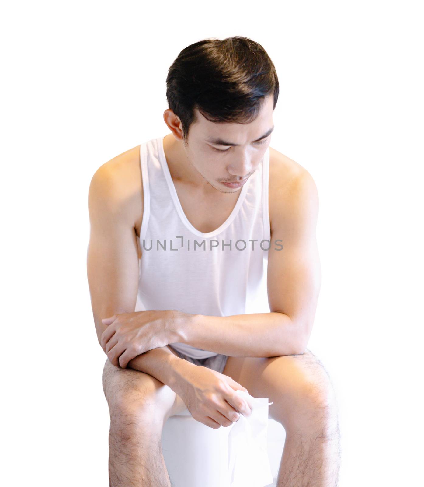 Closeup man sitting on toilet in the morning with depressed feeling isolated on white background