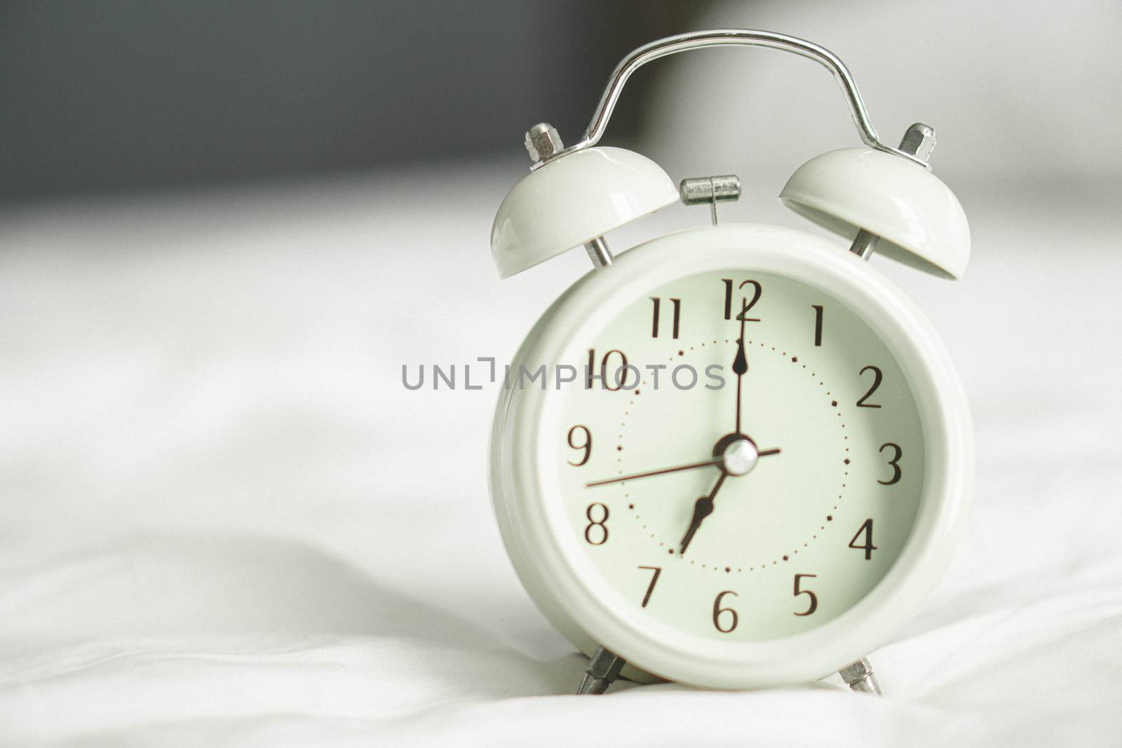 Alarm clock on wooden table for wake up time with light from win by pt.pongsak@gmail.com