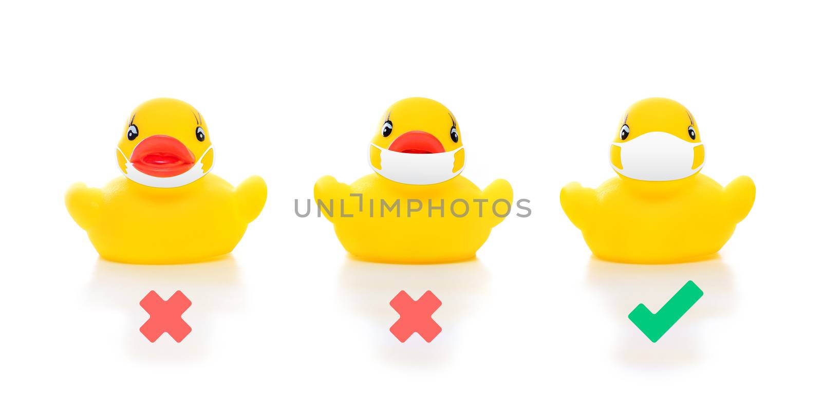 cute yellow rubber ducks in face masks on white background, image shows how to wear mask properly covering over nose and mouth, concept of flu prevention during situation of COVID-19 to stop pandemic