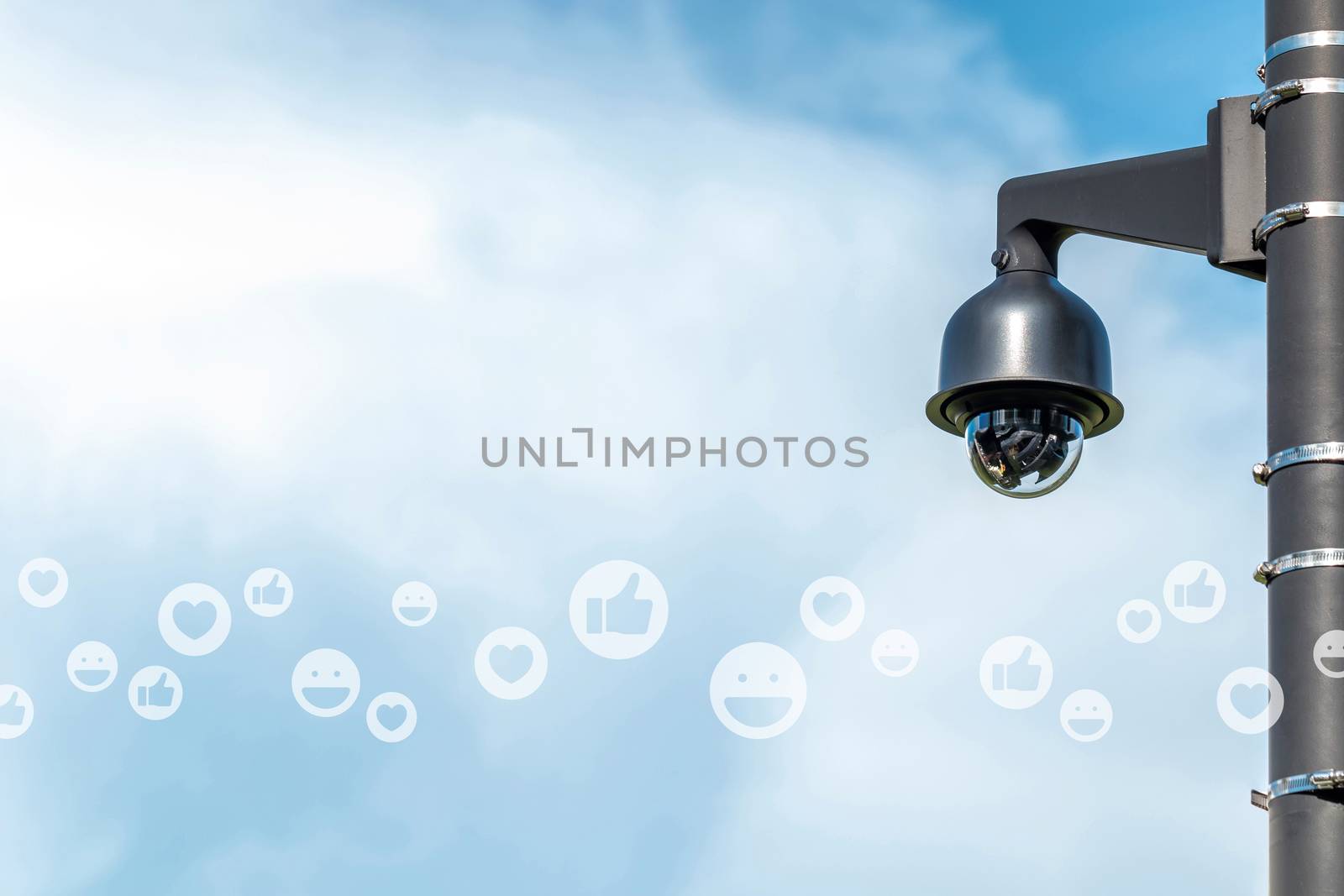 social media icons of thumb up, heart and smile face with CCTV security camera against beautiful sky, concept of social media feedback mornitoring, image with copy space