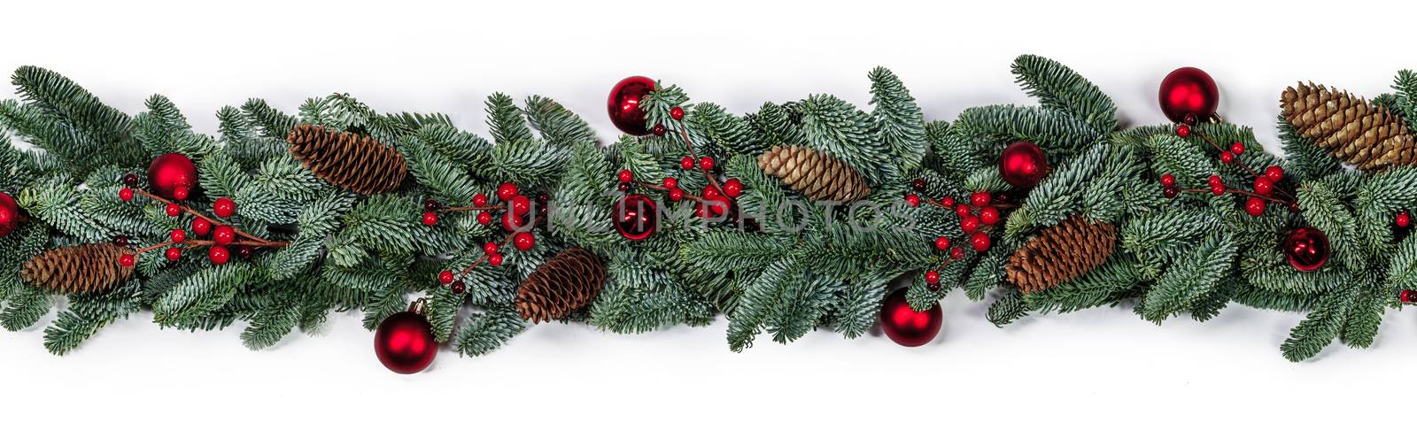 Christmas border frame design copmosition of noble fir tree branch and red decorations balls baubles berries cones isolated on white background