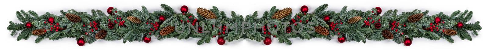 Christmas border frame design copmosition of noble fir tree branch and red decorations balls baubles berries cones isolated on white background