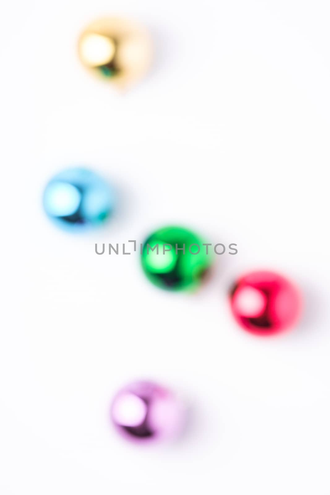 Defocused Christmas New Year composition. Gifts, colorful ball decorations on white background. Winter holidays concept