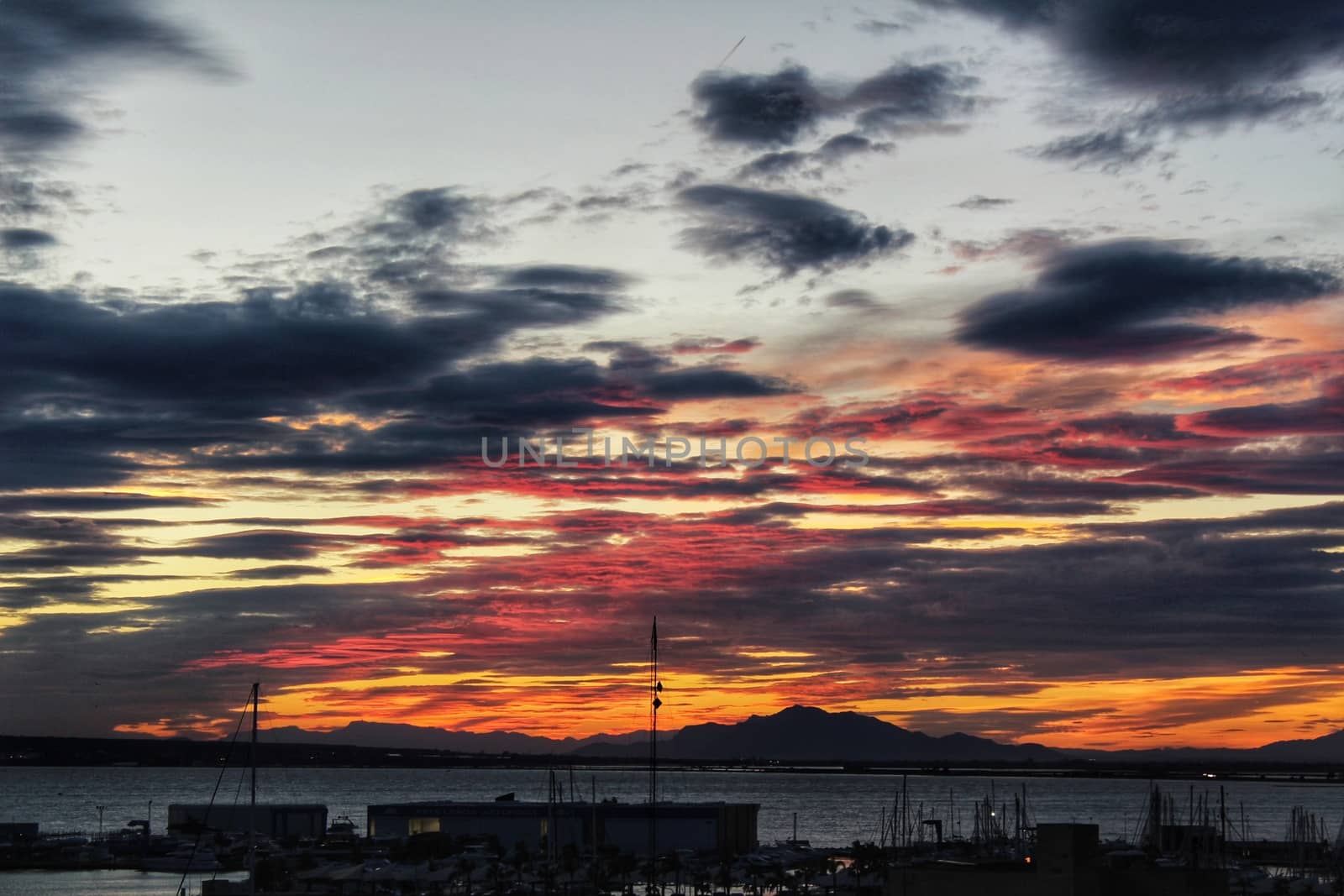 Spectacular and colorful sunset in the bay of Santa Pola, Alicante, Spain in autumn