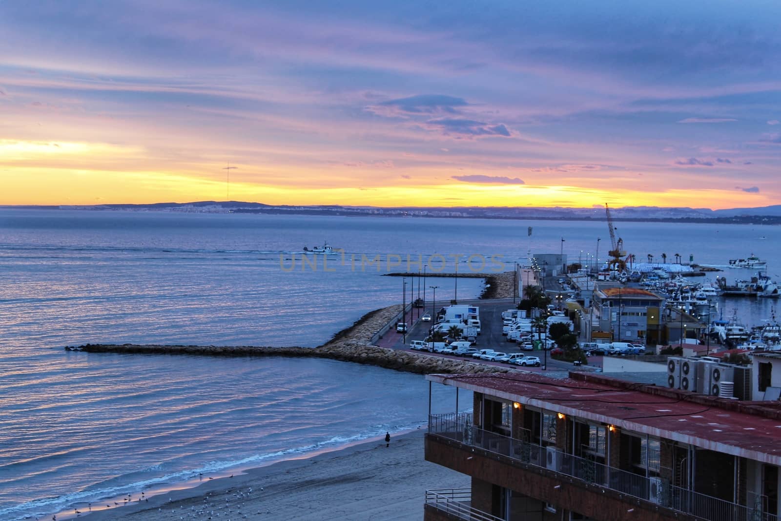 Spectacular and colorful sunset in the bay of Santa Pola, Alicante, Spain in autumn