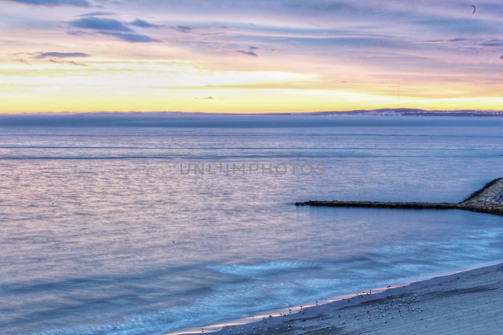 Spectacular and colorful sunset in the bay of Santa Pola, Alicante, Spain in autumn