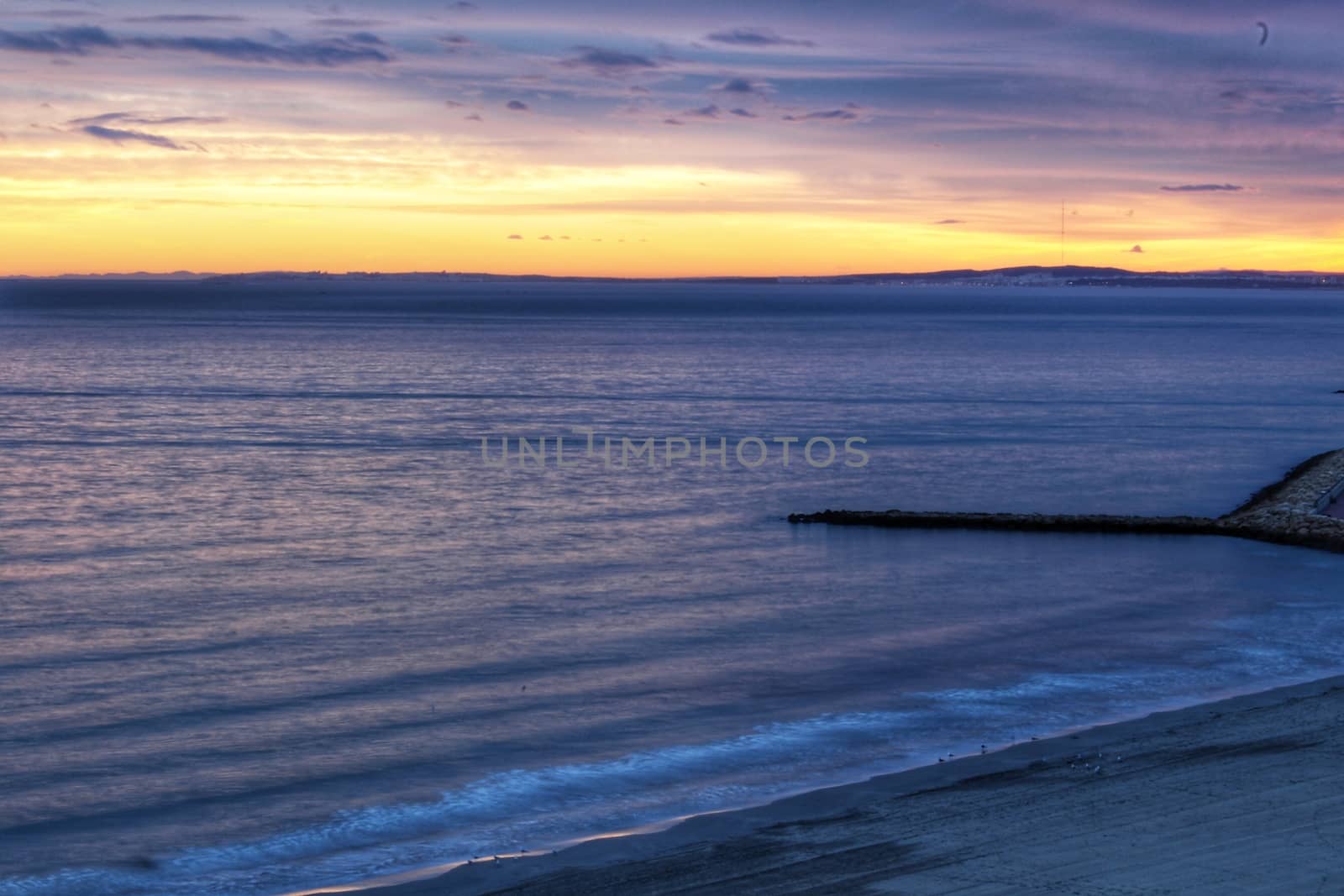 Spectacular and colorful sunset in the bay of Santa Pola, Alicante, Spain in autumn